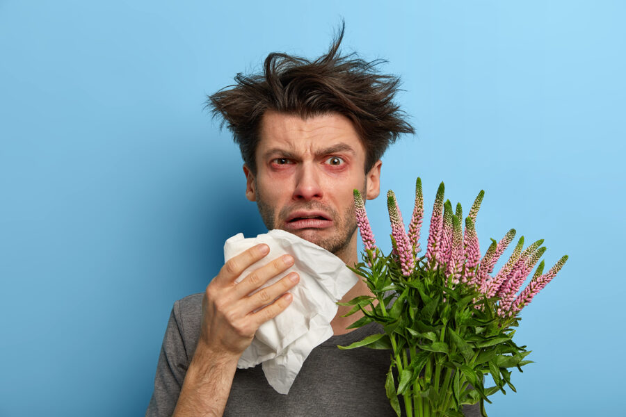 Imagen de un hombre sufriendo un brote de alergia